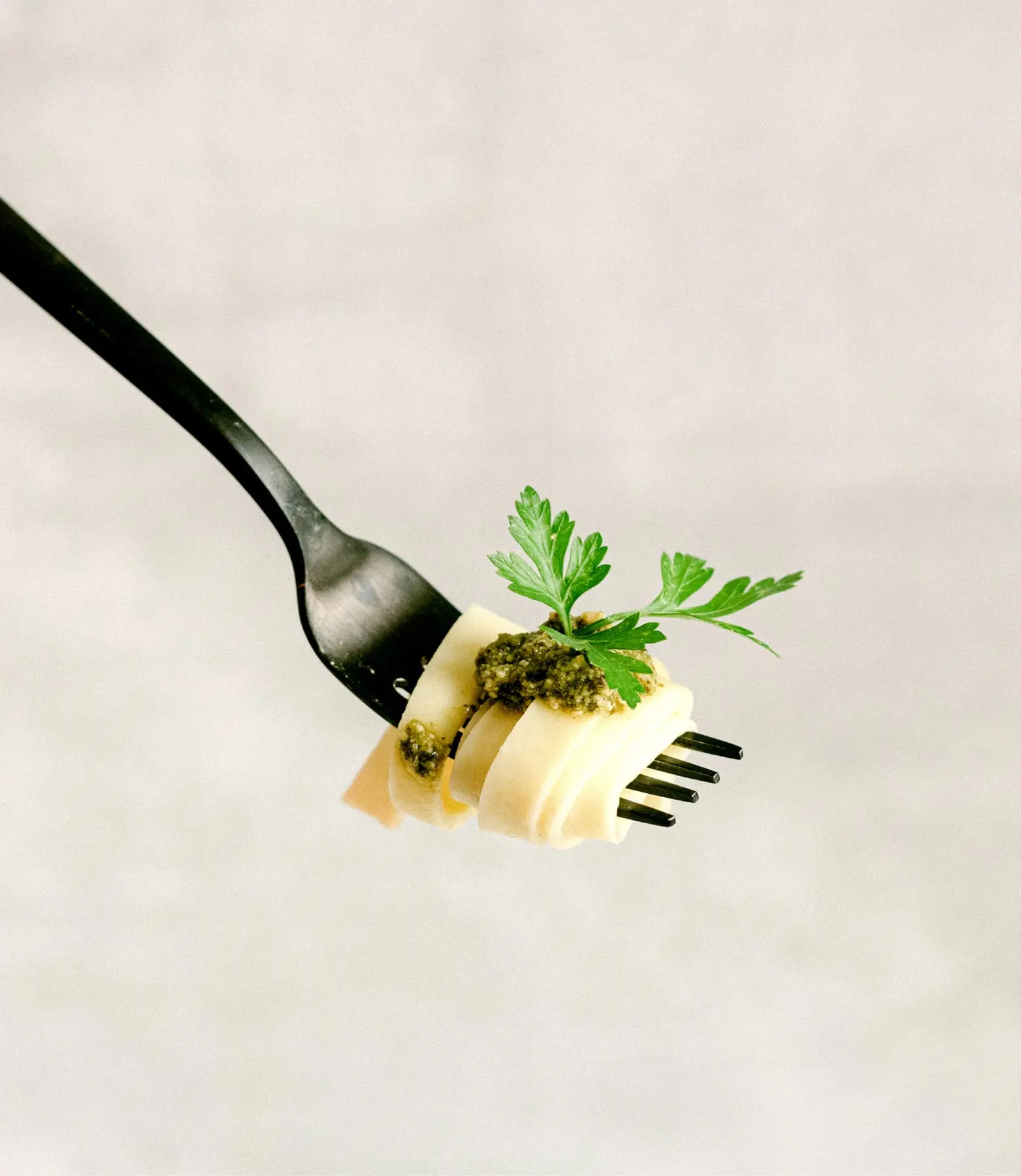 A delicate pasta bite twirled around a fork
